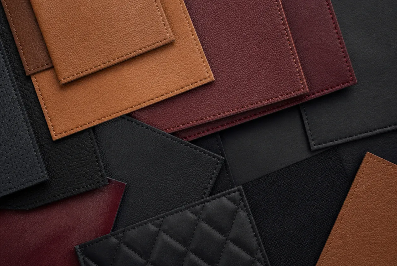 Leather hides and coated fabric samples laid out for a seating specification