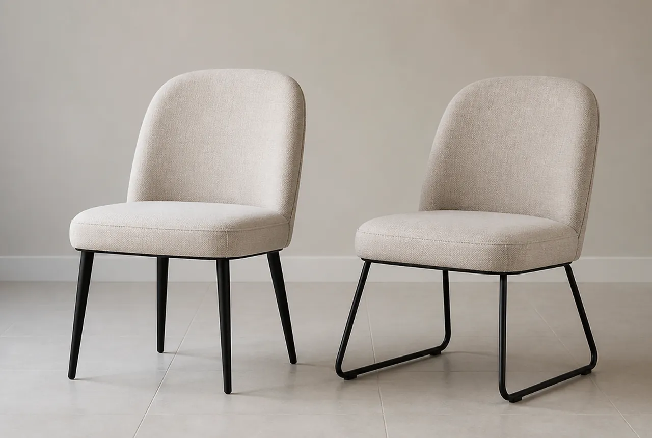 Two side chairs side by side on a pale hard floor, one on four discrete legs and one on a continuous runner base