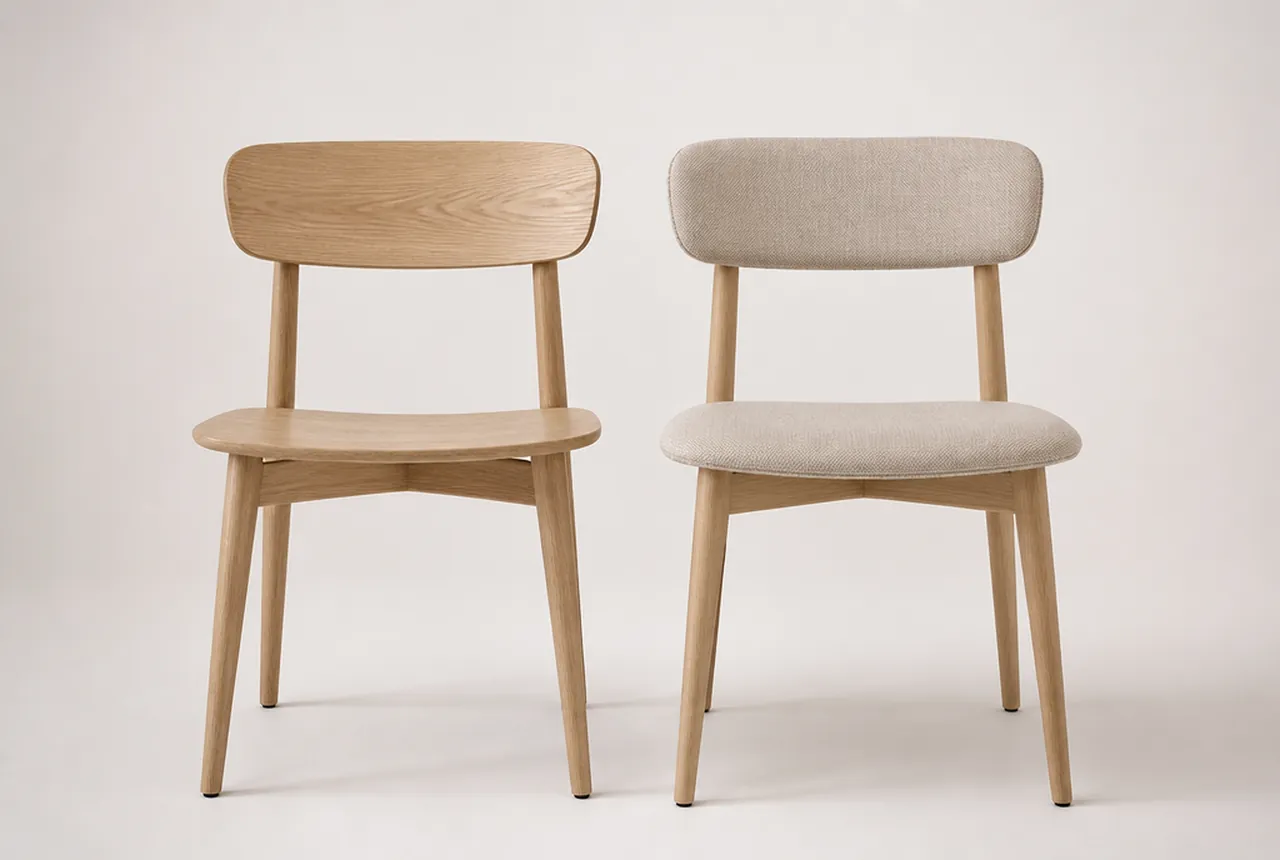Two dining chairs side by side on pale seamless, one wood with a plain seat and one fully upholstered